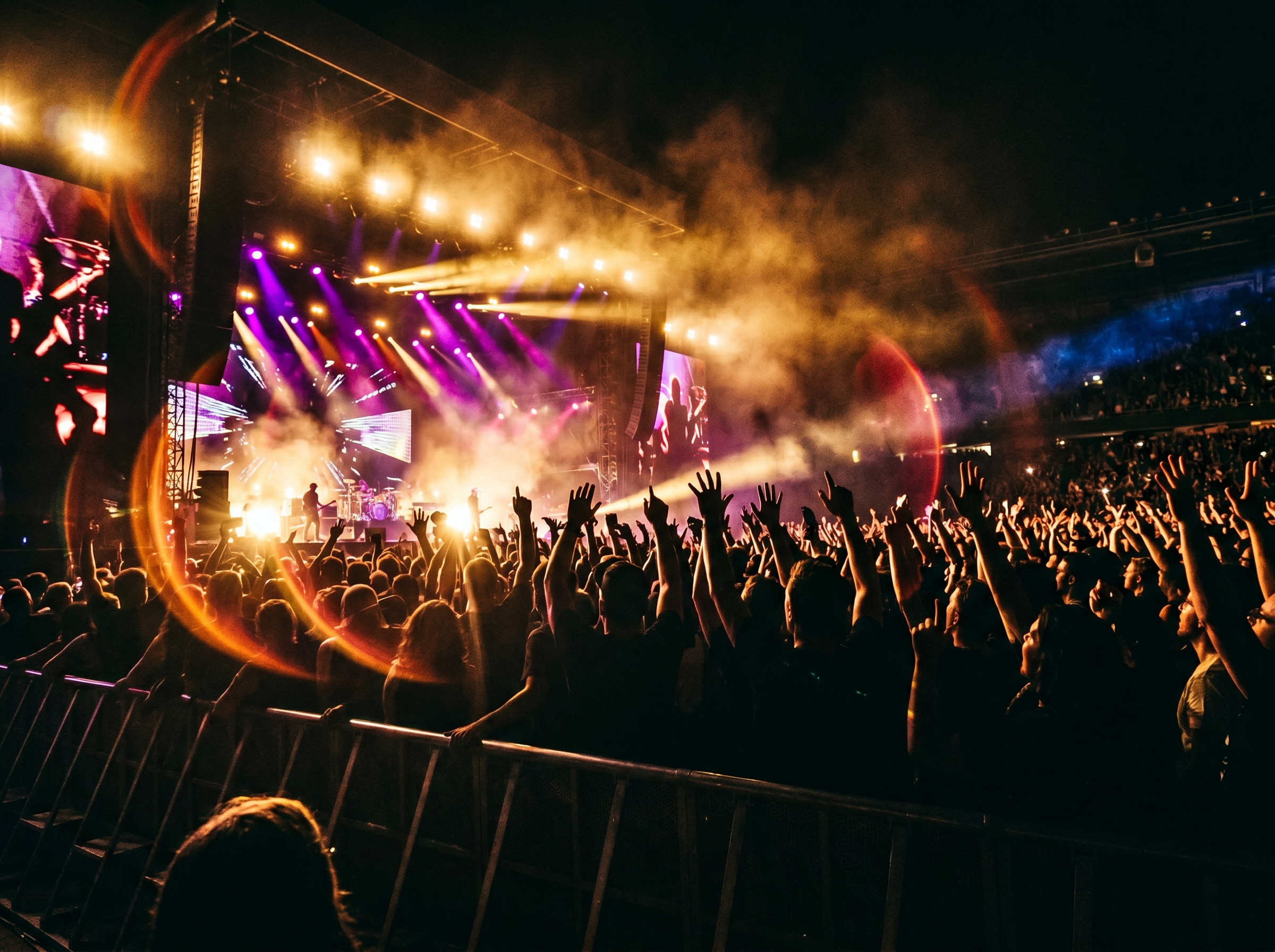 View from the VIP pit of a stadium concert with dramatic stage lights